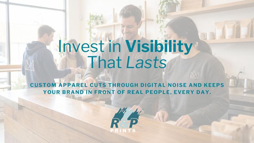 Small business staff wearing custom branded apparel behind a counter, showing how printed merchandise increases everyday brand visibility.